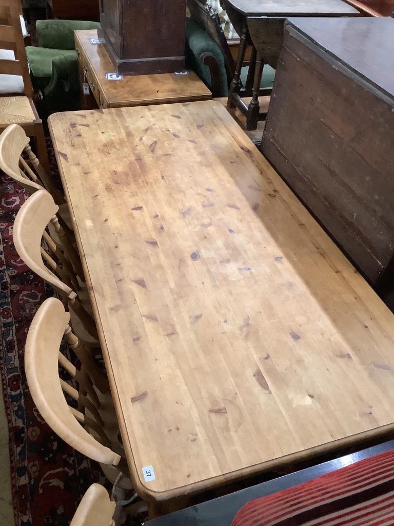 A Victorian style rectangular pine kitchen table, length 180cm, width 86cm, height 77cm and four beech Windsor kitchen chairs